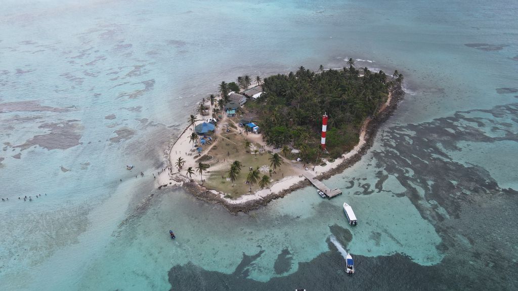 Aerial view of a small tropical island with a lighthouse in San Andrés, Colombia.