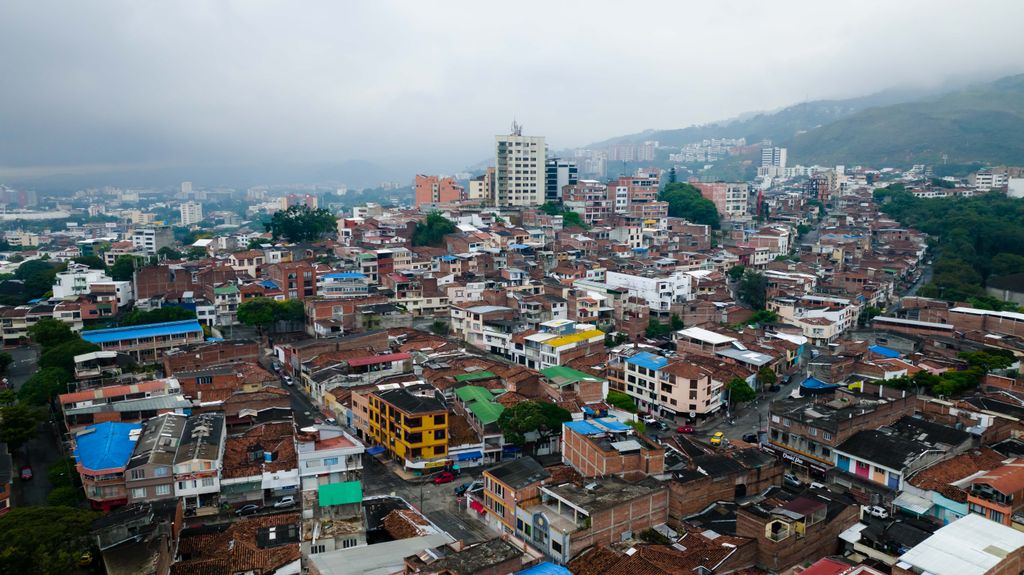 Aerial view showcasing a vibrant urban landscape with diverse buildings under an overcast sky.