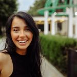 Captivating portrait of a cheerful young woman outdoors in Tbilisi, showcasing natural beauty.